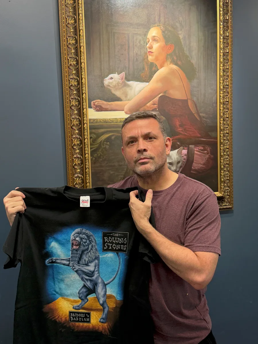 Kevin Murphy standing in front of one of his paintings