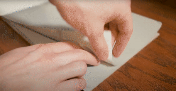 Taping down a piece of palette paper prevents the edges from curling up over time. 